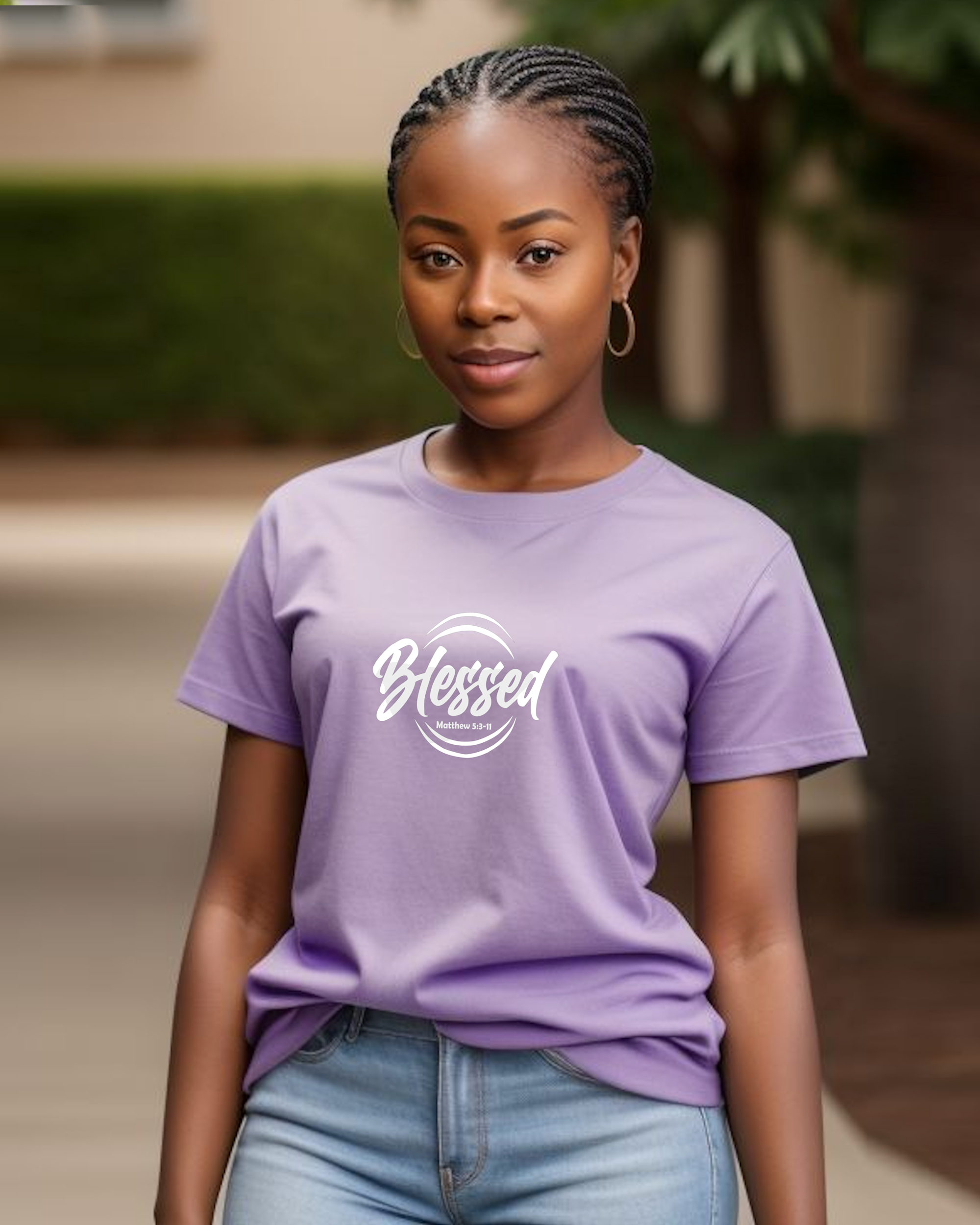 A young woman wearing a purple t-shirt with a white text logo that says 'Blessed' t-shirt in a garden.
