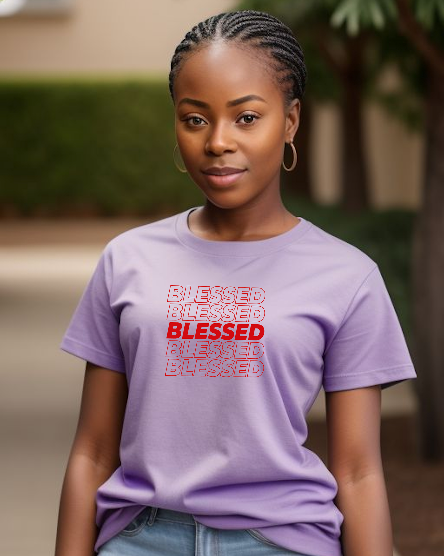 A young woman in a garden wearing a light purple t-shirt with multiple lines of "Blessed" text printed on the front.