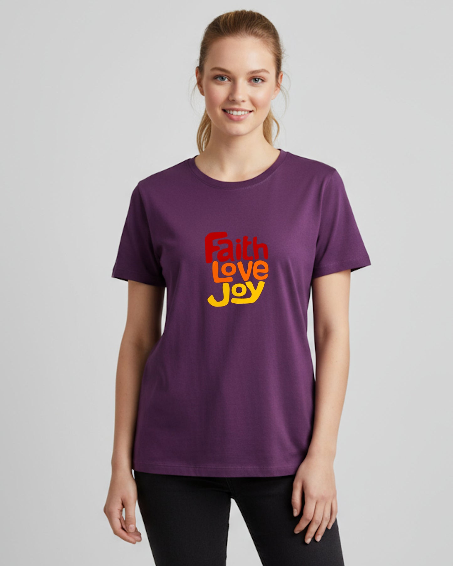 Woman wearing a purple t-shirt with 'Faith Love Joy' text on a plain background