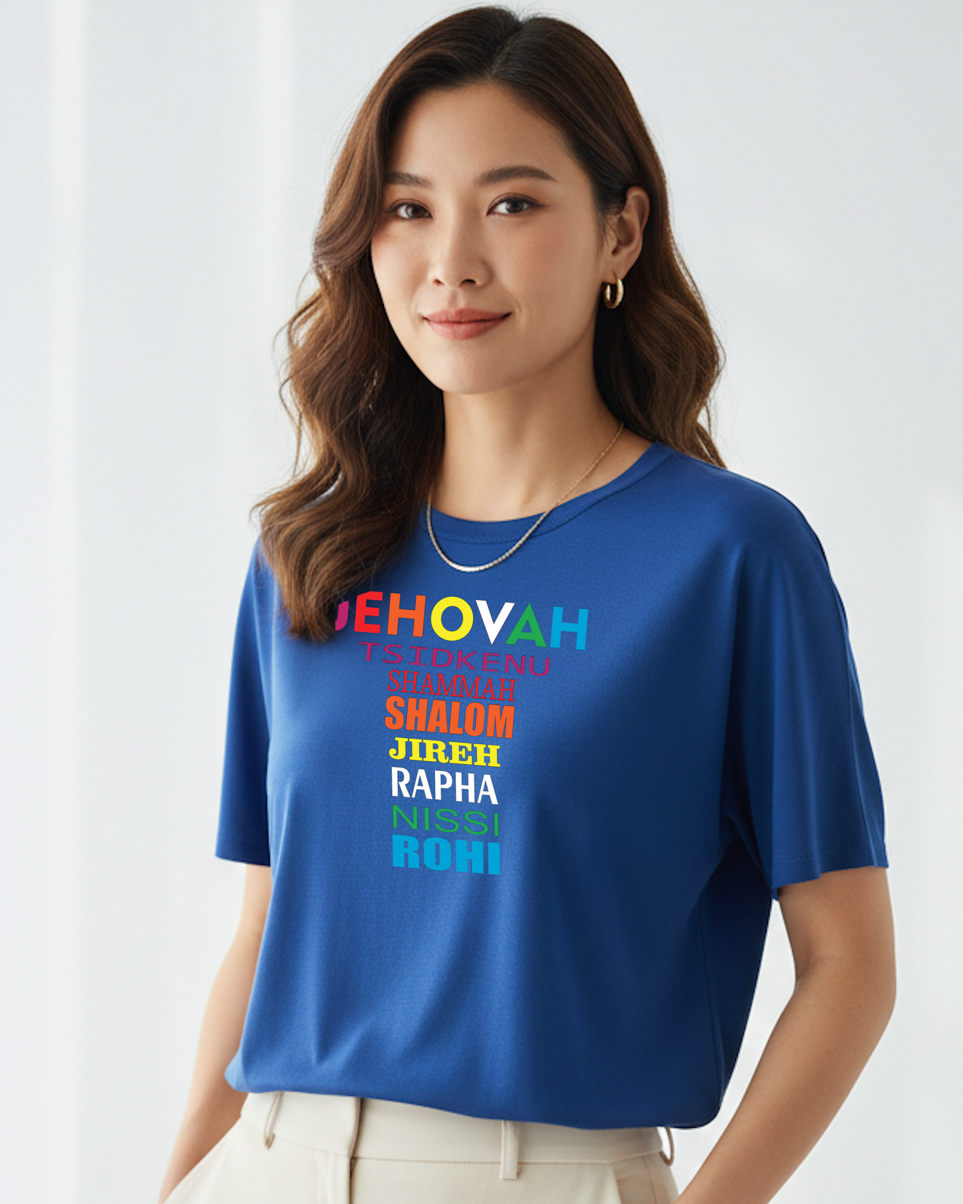 Woman wearing a blue t-shirt with colorful text on a white background