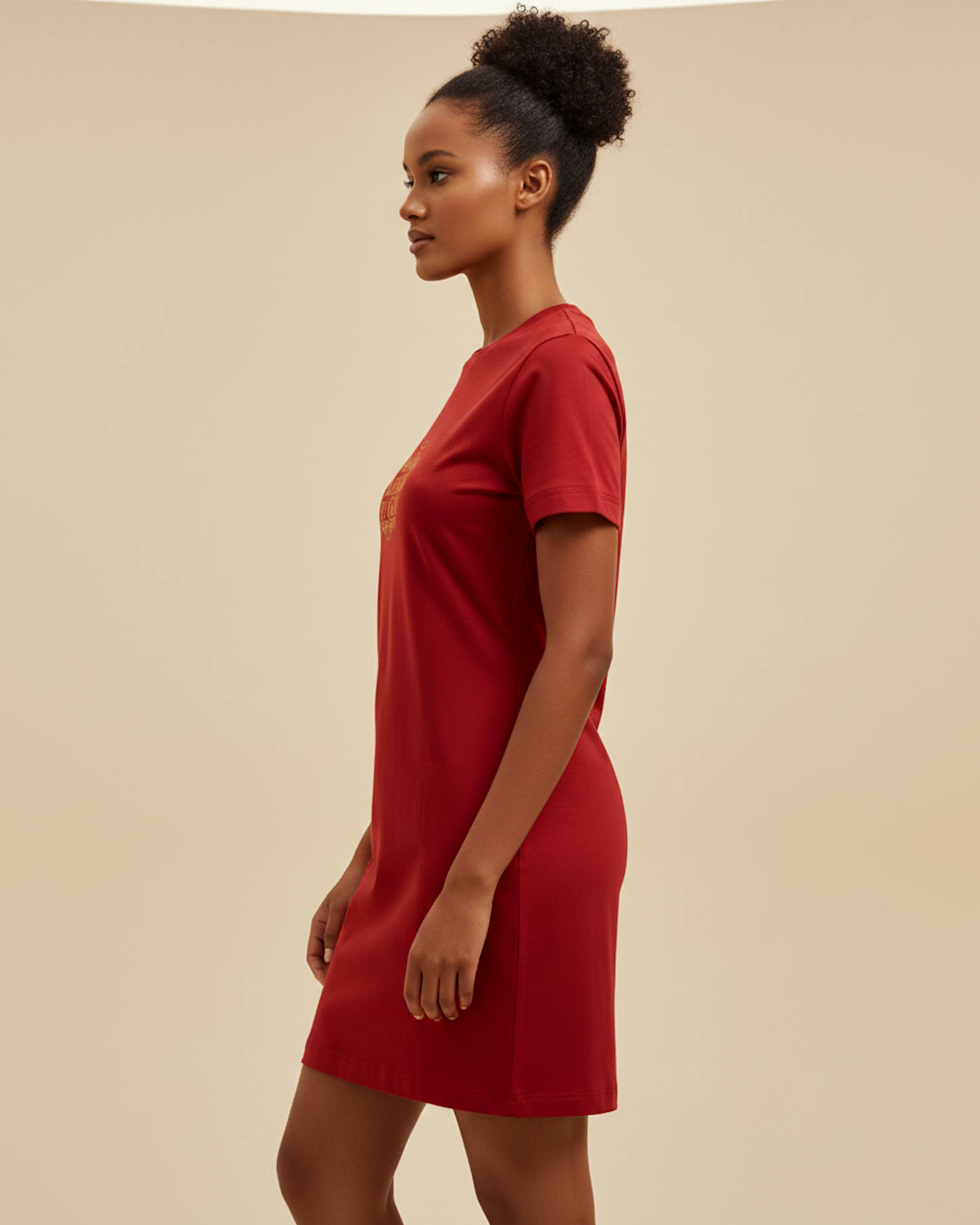 Side view of a woman wearing a red t-shirt dress.
