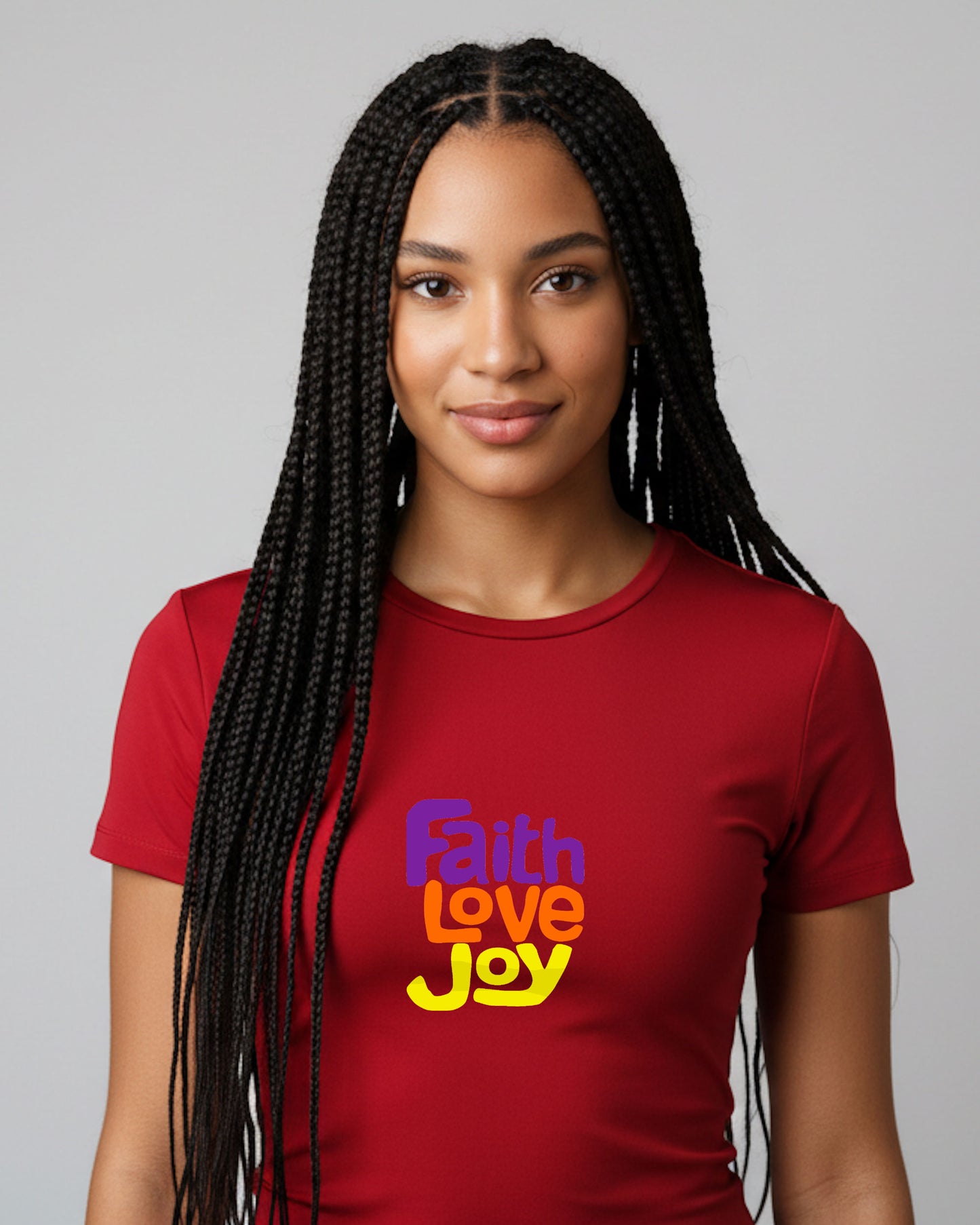 Woman wearing a red t-shirt with 'Faith Love Joy' text on a gray background