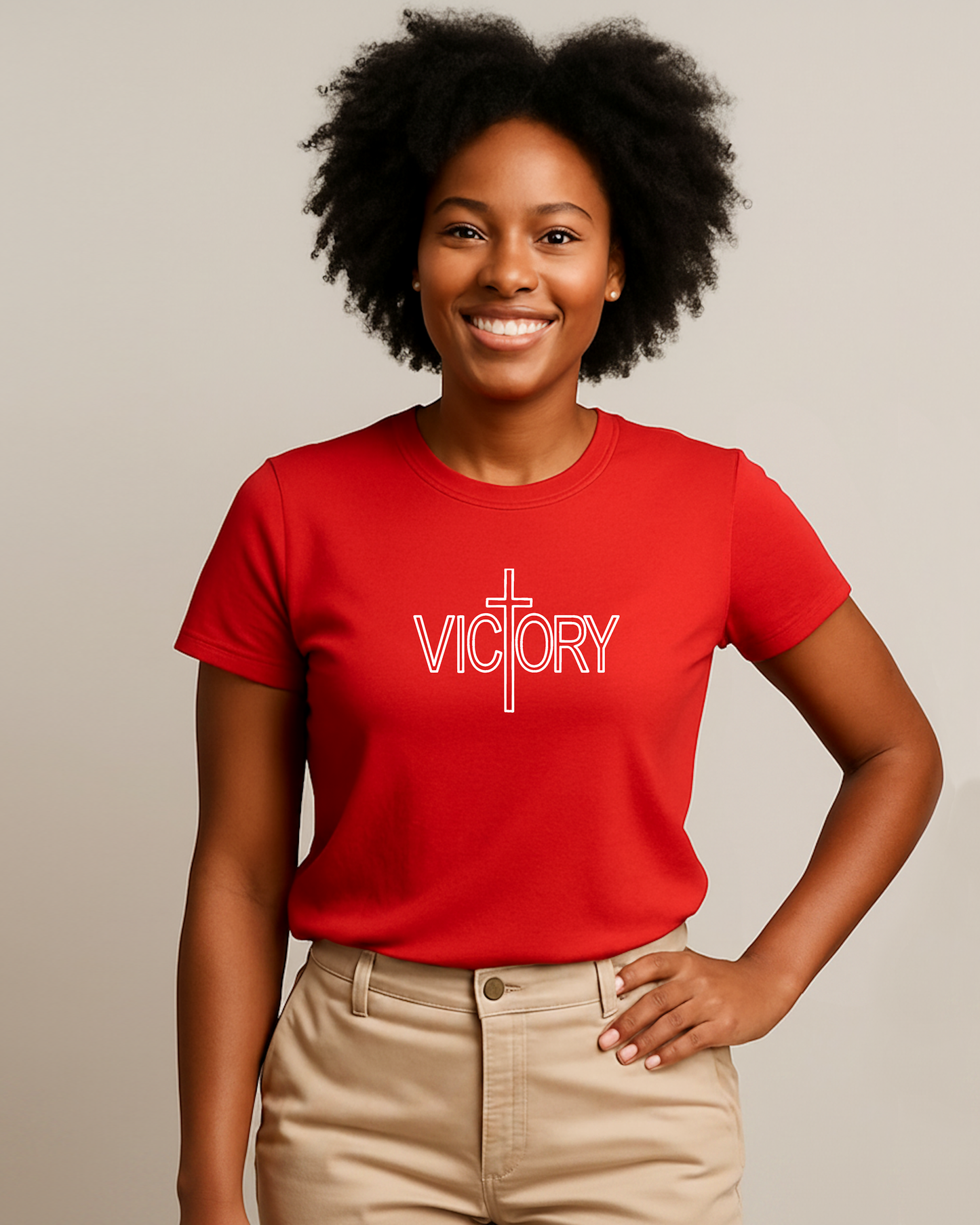 Woman wearing a red 'VICTORY' t-shirt against a neutral background