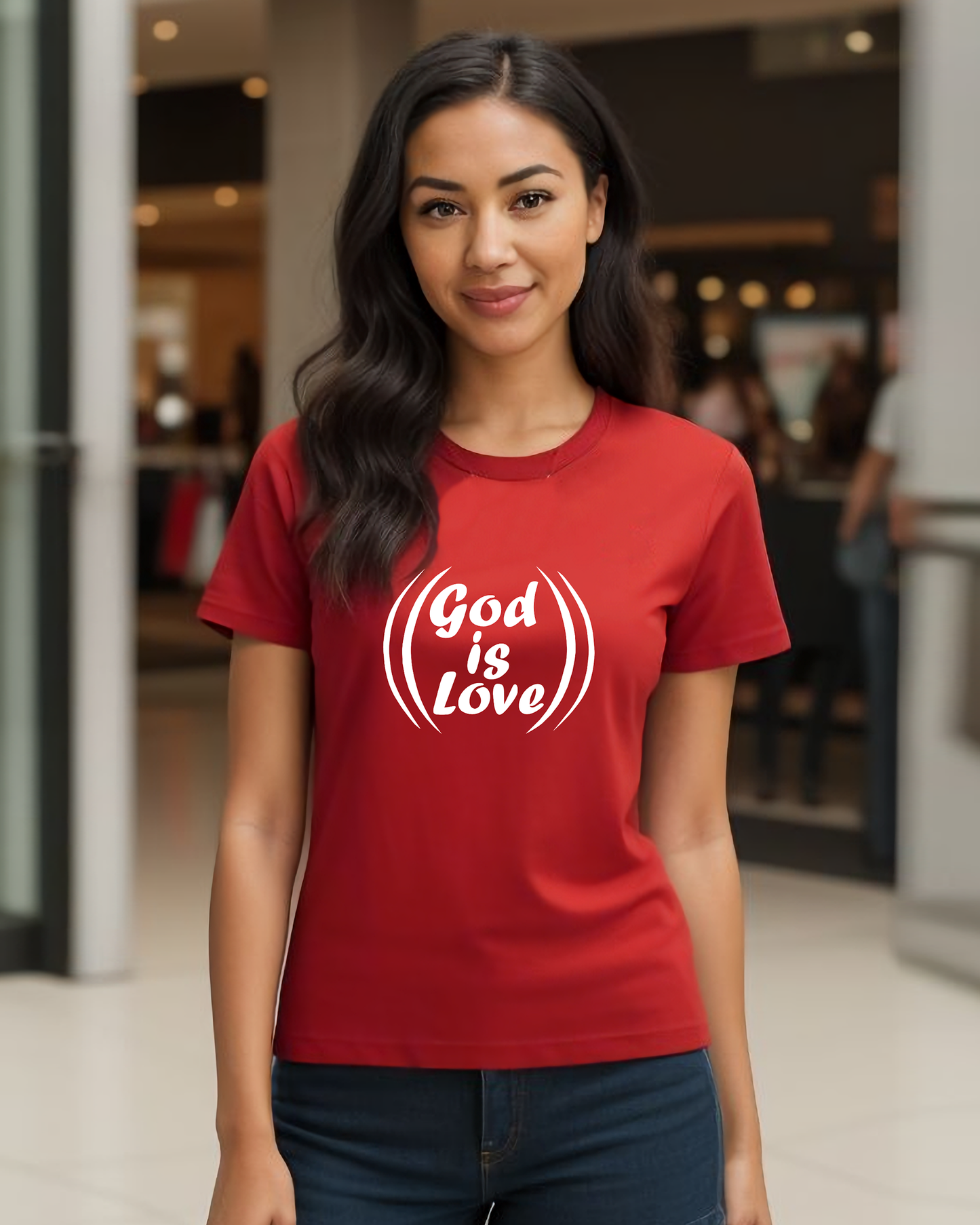 A woman in a shopping mall wearing a red t-shirt with a white "God is Love" logo printed on the front.