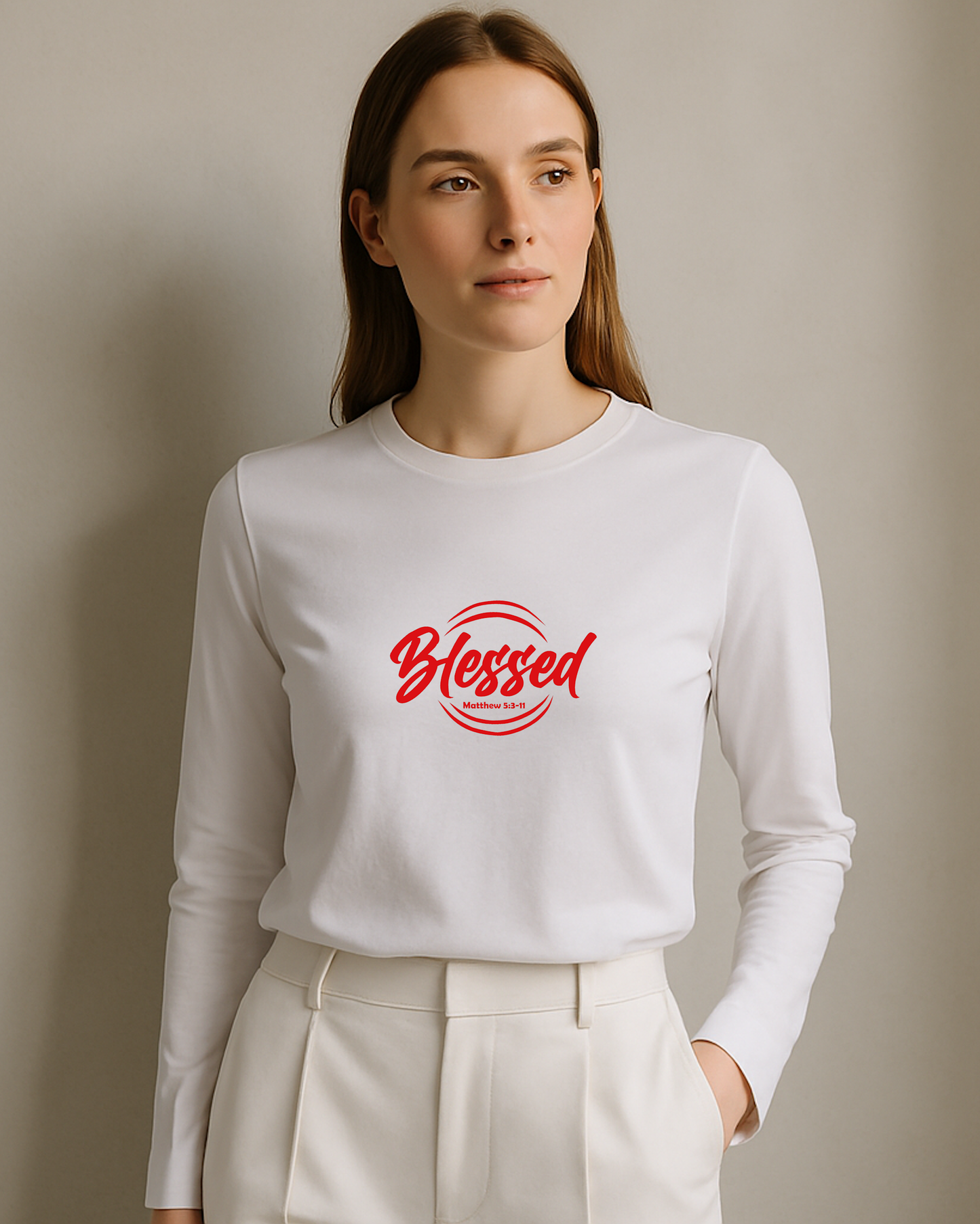 Woman wearing a white long-sleeve shirt with 'Blessed' in red text on a plain background