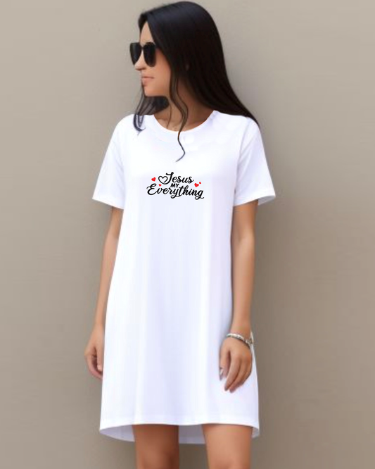 Woman wearing a dark green Heavenly Dreamwear t-shirt dress standing against a wall with a black text logo "Jesus MY Everything" with 4 red hearts printed on the dress.