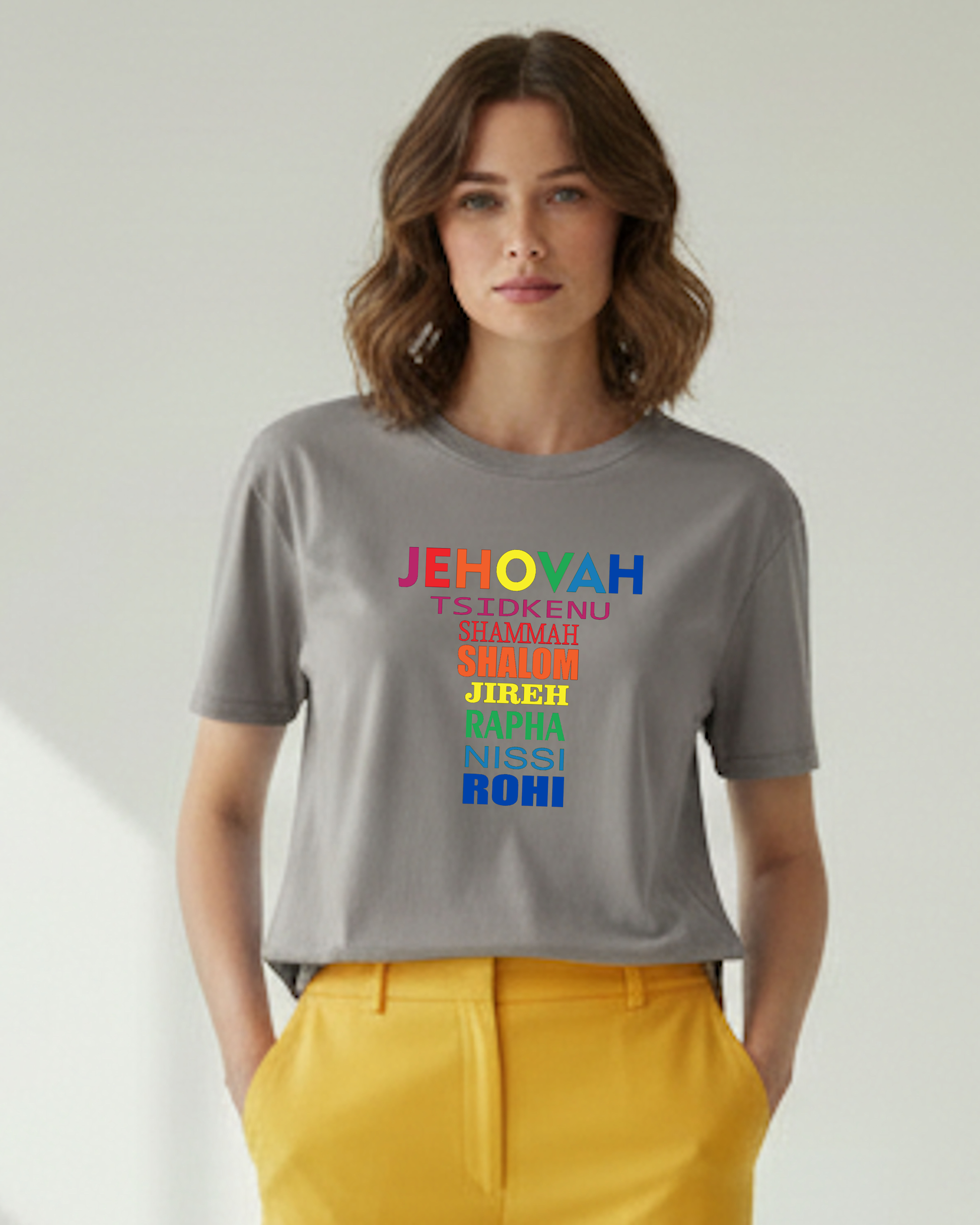 Woman wearing a grey t-shirt with colorful Hebrew text on a plain background