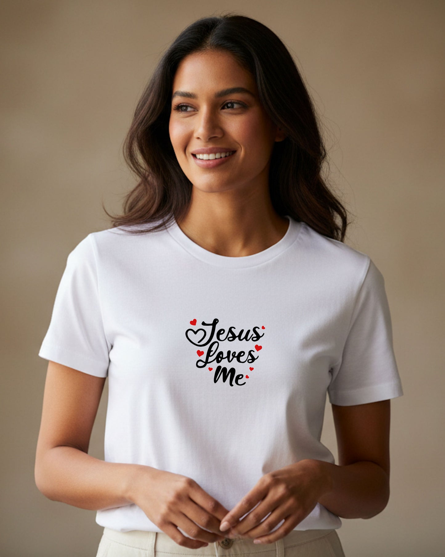 A woman wearing a white t-shirt with black 'Jesus loves me' text and red hearts against a beige background.