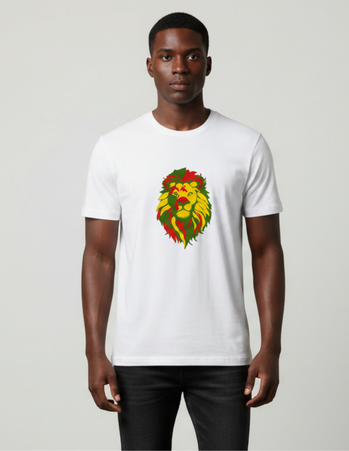 A man wearing a white crew-neck t-shirt with a red, yellow and green lion graphic on the chest, paired with black pants, standing against a light gray studio background.