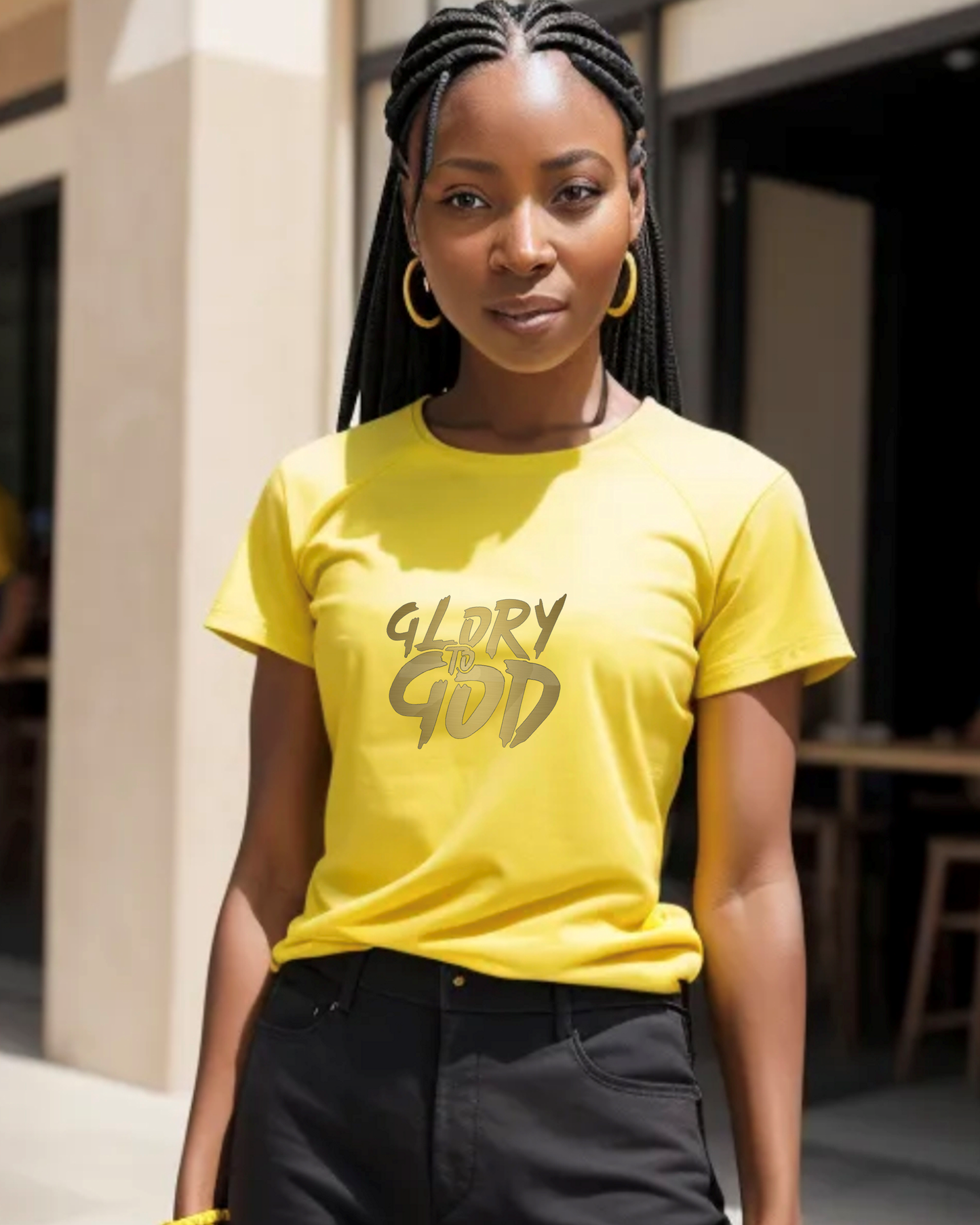 A woman wearing a yellow t-shirt with a gold Heavenly Dreamwear "Glory to God" logo printed on the front.