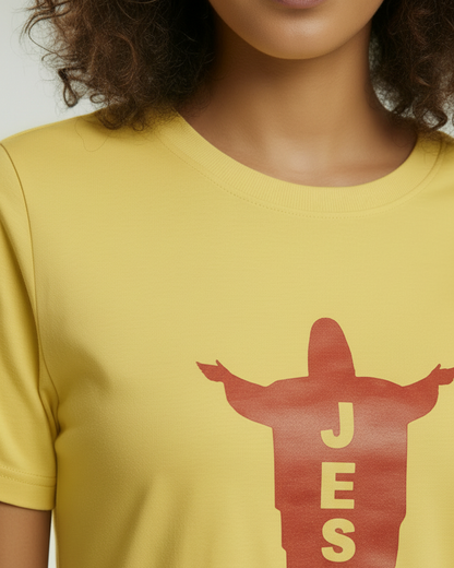 View of neckline of a woman wearing a yellow t-shirt dress with a red Jesus logo on the front.