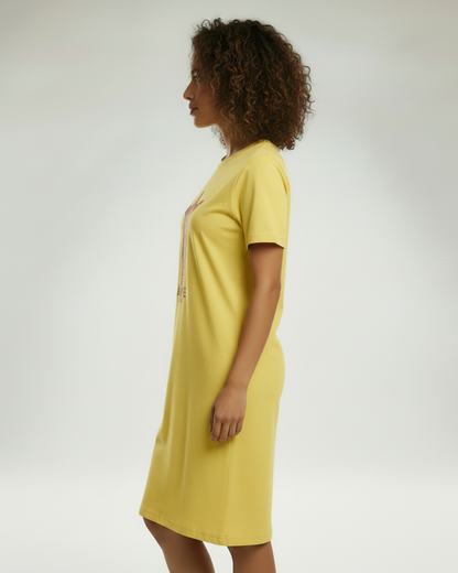 Side view of a woman wearing a yellow t-shirt dress.