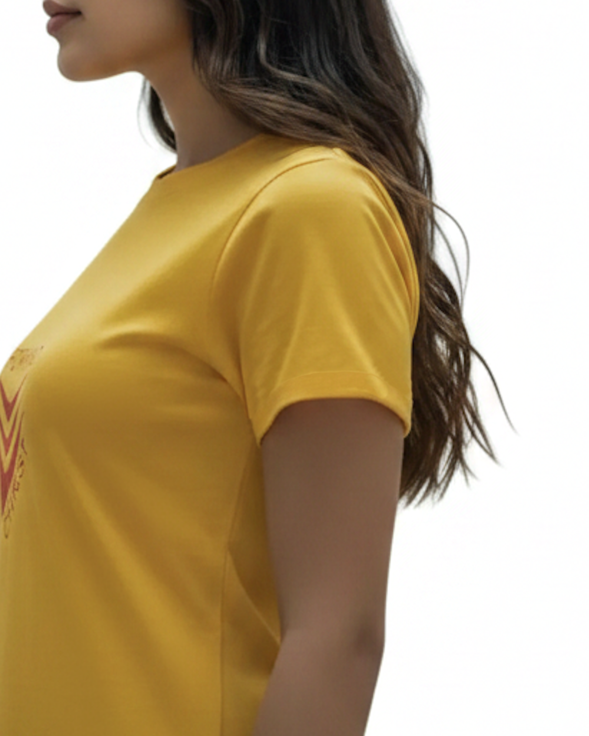 Closeup view of the sleeve of a yellow t-shirt dress with a red logo worn by a woman against a white background.