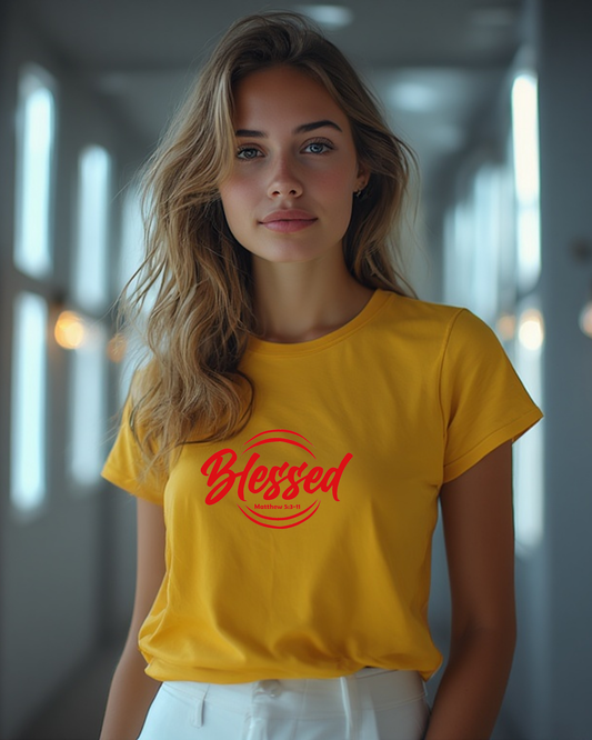A young smiling woman wearing a yellow t-shirt with a red text logo that says 'Blessed'