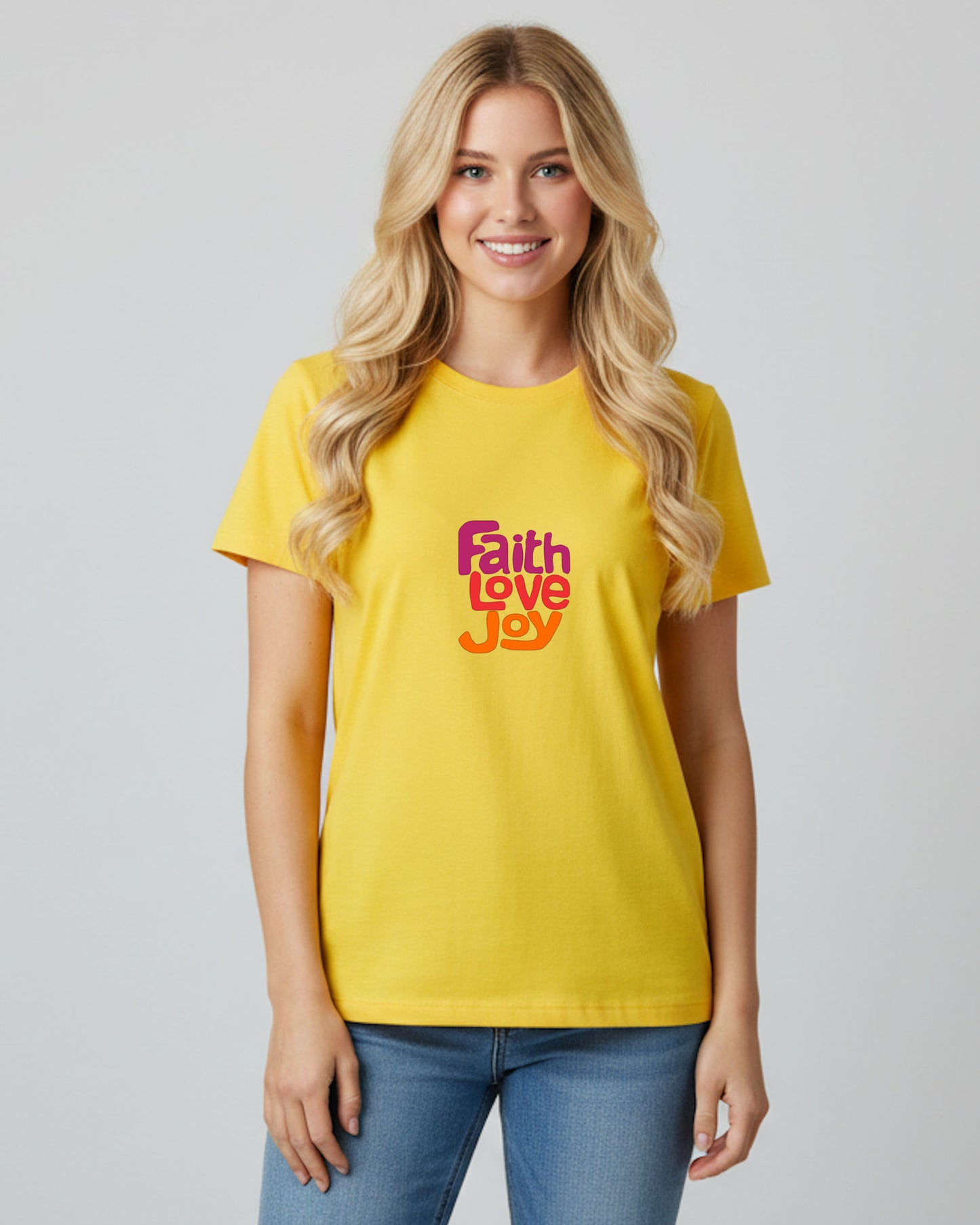 Woman wearing a yellow t-shirt with 'Faith Love Joy' text on a plain background
