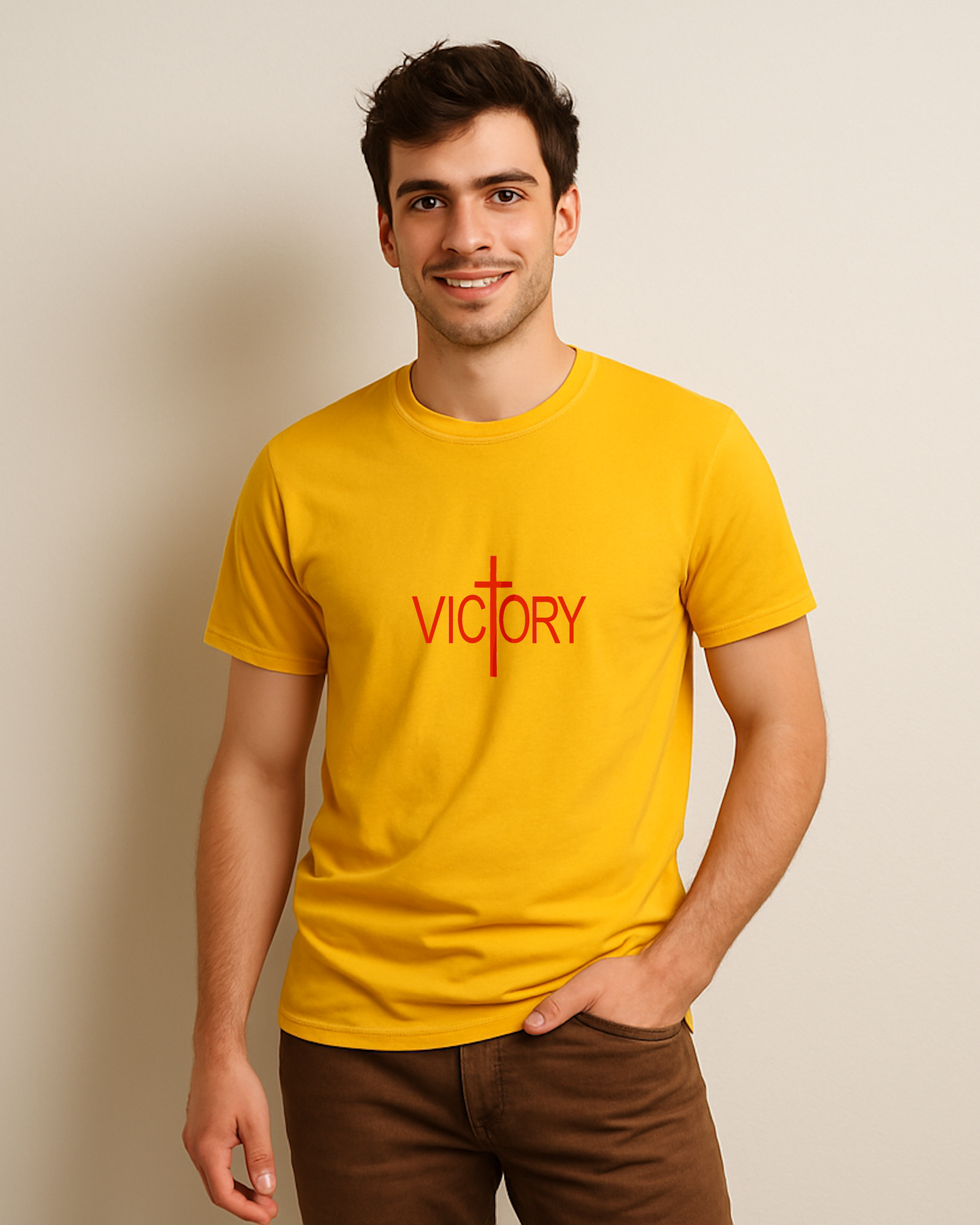 A man wearing a yellow t-shirt with a white Heavenly Dreamwear "Victory" logo printed on the front.